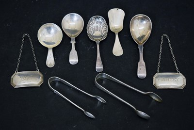Lot 259 - A collection of silver spoons, sugar tongs and decanter lables
