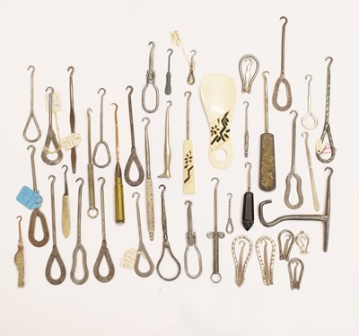 Lot 482 - A collection of advertising, folding and other novelty button hooks