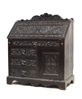 Lot 738 - 20th century carved oak bureau