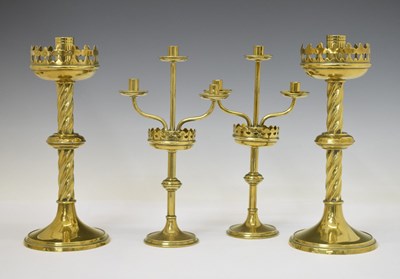 Lot 445 - Two pairs of brass altar candlesticks