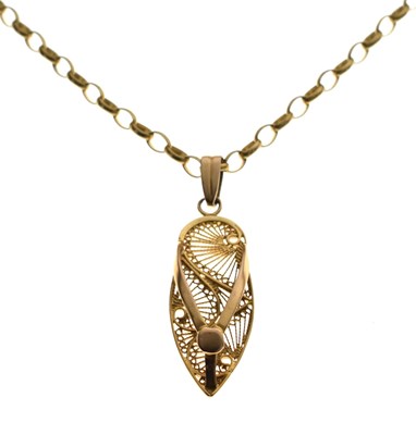 Lot 95 - Yellow metal filigree 'sandal' pendant on belcher chain