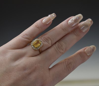 Lot 29 - Imperial yellow topaz and diamond cluster ring