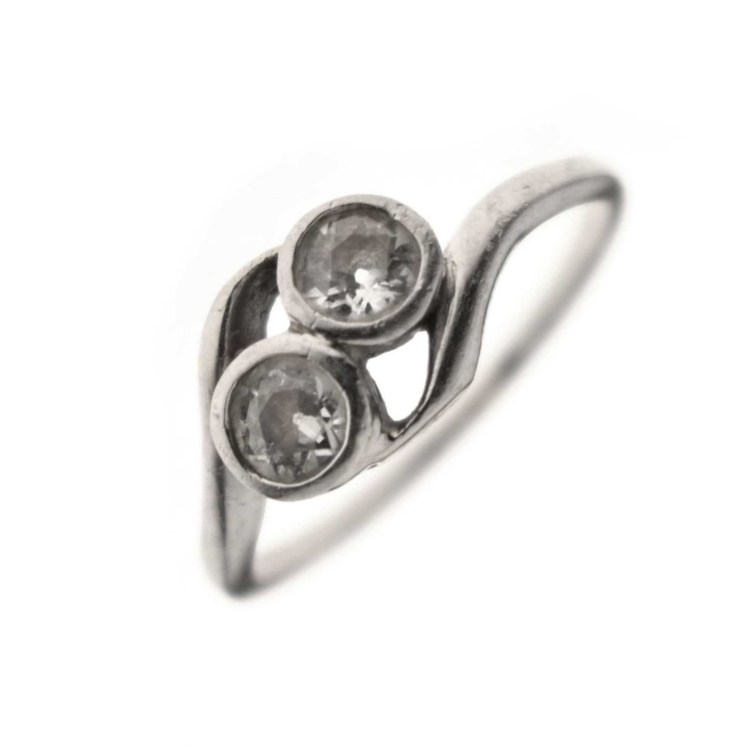 Lot 5 - Diamond two stone unmarked white metal crossover ring