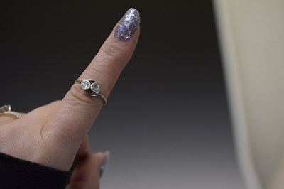 Lot 5 - Diamond two stone unmarked white metal crossover ring