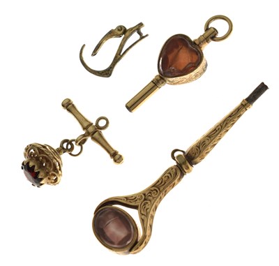 Lot 191 - Two yellow metal and hardstone watch winders, fob, and clip