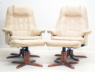 Lot 735 - Pair of cream leather swivel recliner chairs with footstools