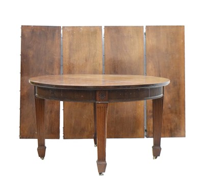 Lot 497 - Edwardian mahogany wind-out extending D-end dining table with four additional leaves