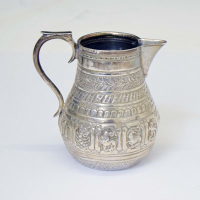 Lot 249 - Victorian silver cream jug decorated with embossed symbols of the zodiac