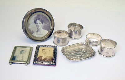 Lot 227 - Collection of silver items, a pair of George V napkin rings, a Victorian silver pin dish, silver frames, etc