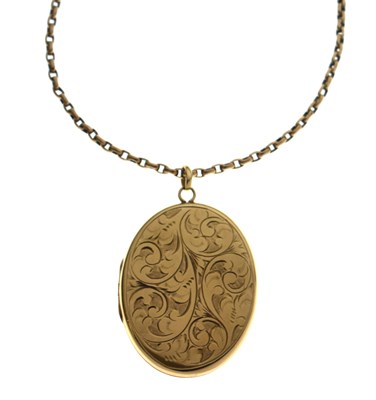 Lot 133 - Large 9ct gold engraved oval locket, on a yellow metal belcher link chain, tagged 9c