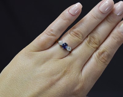 Lot 19 - Sapphire and diamond three stone 18ct yellow gold and platinum set ring