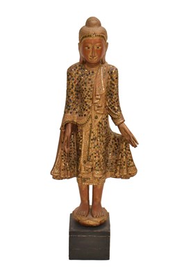 Lot 629 - Large South East Asian red lacquered carved wood and glass standing Buddha