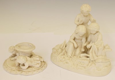 Lot 568 - Parian ware group of three children plus figural candlestick (2)