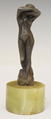 Lot 390 - Early 20th century cast metal figure of a standing naked female