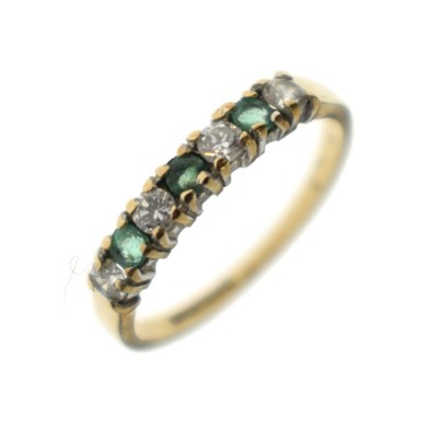 Lot 38 - Emerald and cubic zirconia 9ct gold half eternity ring
