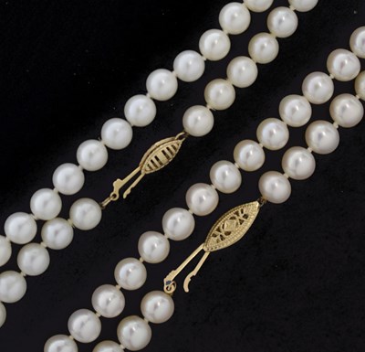 Lot 116 - Two cultured freshwater pearl necklaces, each having a yellow metal clasp stamped '14K'