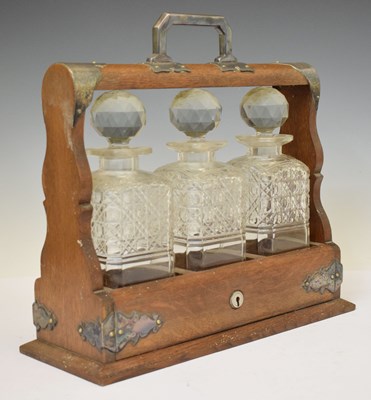 Lot 271 - Early 20th century oak three-bottle tantalus
