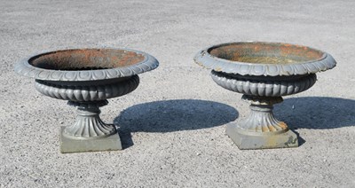Lot 627 - Pair of cast iron garden urns or planters