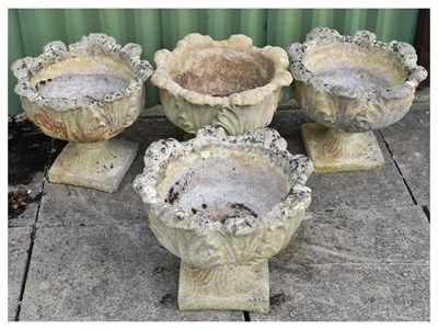 Lot 835 - Set of four composition stone garden urns