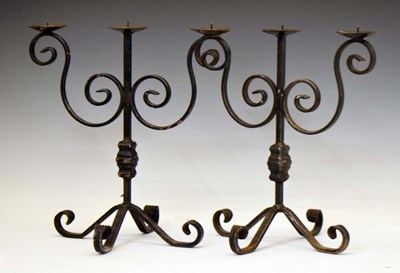 Lot 225 - Pair of wrought iron two branch (three light) pricket table candelabra