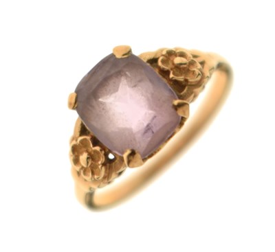 Lot 15 - Yellow metal dress ring set an amethyst coloured stone