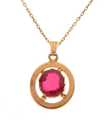 Lot 69 - Red paste set yellow metal pendant, on chain