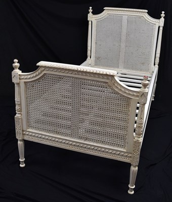Lot 556 - French-style cream painted single bed with caned head and footboards