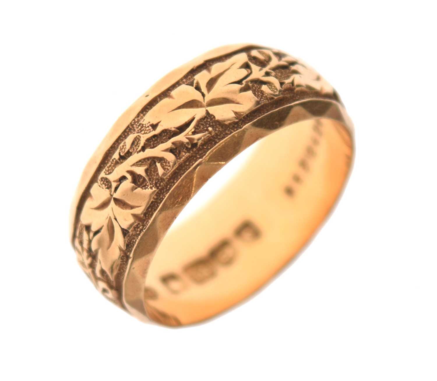 Lot 50 - 18ct gold wedding band with foliate decoration