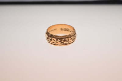 Lot 50 - 18ct gold wedding band with foliate decoration