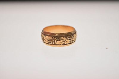 Lot 50 - 18ct gold wedding band with foliate decoration