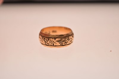 Lot 50 - 18ct gold wedding band with foliate decoration