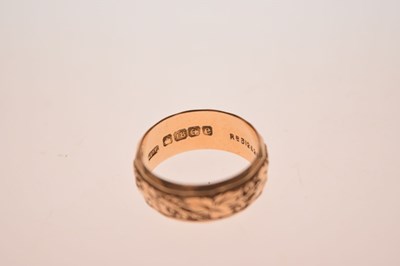 Lot 50 - 18ct gold wedding band with foliate decoration