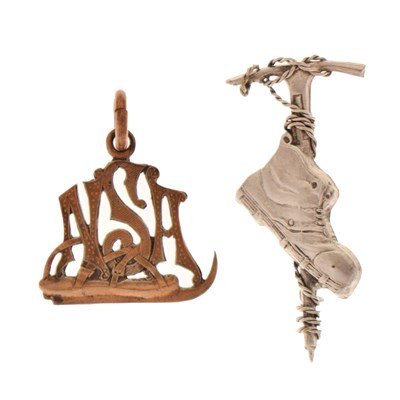 Lot 63 - White metal mountaineering brooch and a National Skating Association (NSA) fob (2)