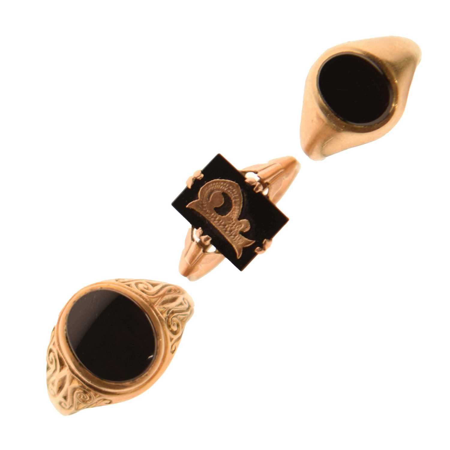 Lot 24 - Two 9ct and black onyx rings together with a similar yellow metal example