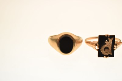 Lot 24 - Two 9ct and black onyx rings together with a similar yellow metal example