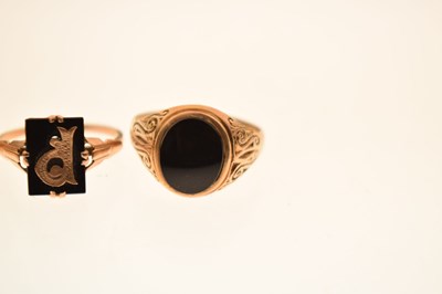 Lot 24 - Two 9ct and black onyx rings together with a similar yellow metal example
