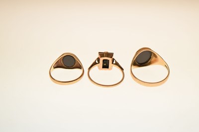 Lot 24 - Two 9ct and black onyx rings together with a similar yellow metal example