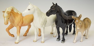 Lot 415 - Three Beswick horses and a donkey foal