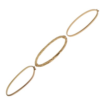 Lot 127 - Three 9ct gold hinged oval bangles