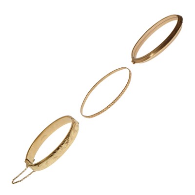 Lot 128 - Two 9ct gold bangles and a rolled gold bangle (3)