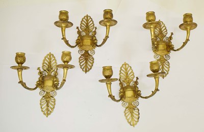 Lot 297 - Set of four French gilt metal two-branch wall sconces