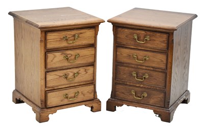 Lot 588 - Pair of reproduction oak four-drawer bedroom chests