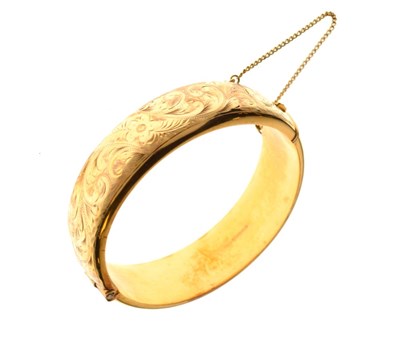 Lot 65 - 9ct gold half engraved hinged bangle