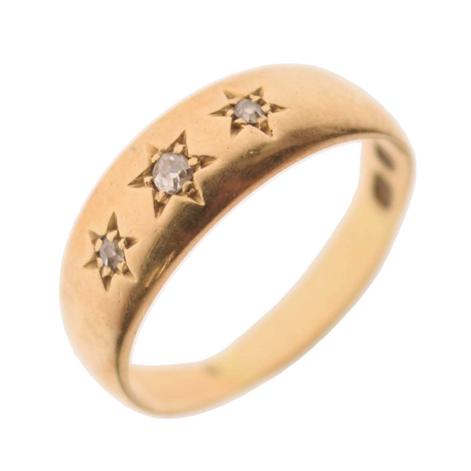 Lot 11 - Gypsy set three stone diamond yellow metal ring