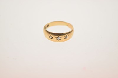 Lot 11 - Gypsy set three stone diamond yellow metal ring