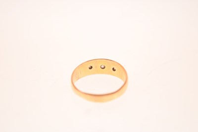Lot 11 - Gypsy set three stone diamond yellow metal ring