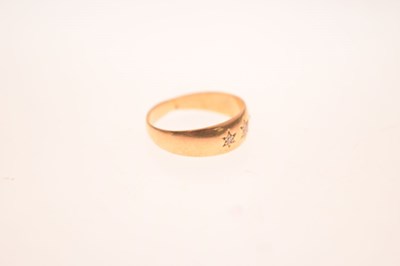Lot 11 - Gypsy set three stone diamond yellow metal ring