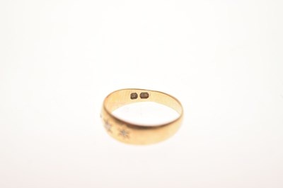 Lot 11 - Gypsy set three stone diamond yellow metal ring