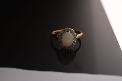 Lot 17 - Opal and diamond yellow metal ring