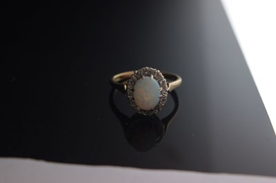 Lot 17 - Opal and diamond yellow metal ring